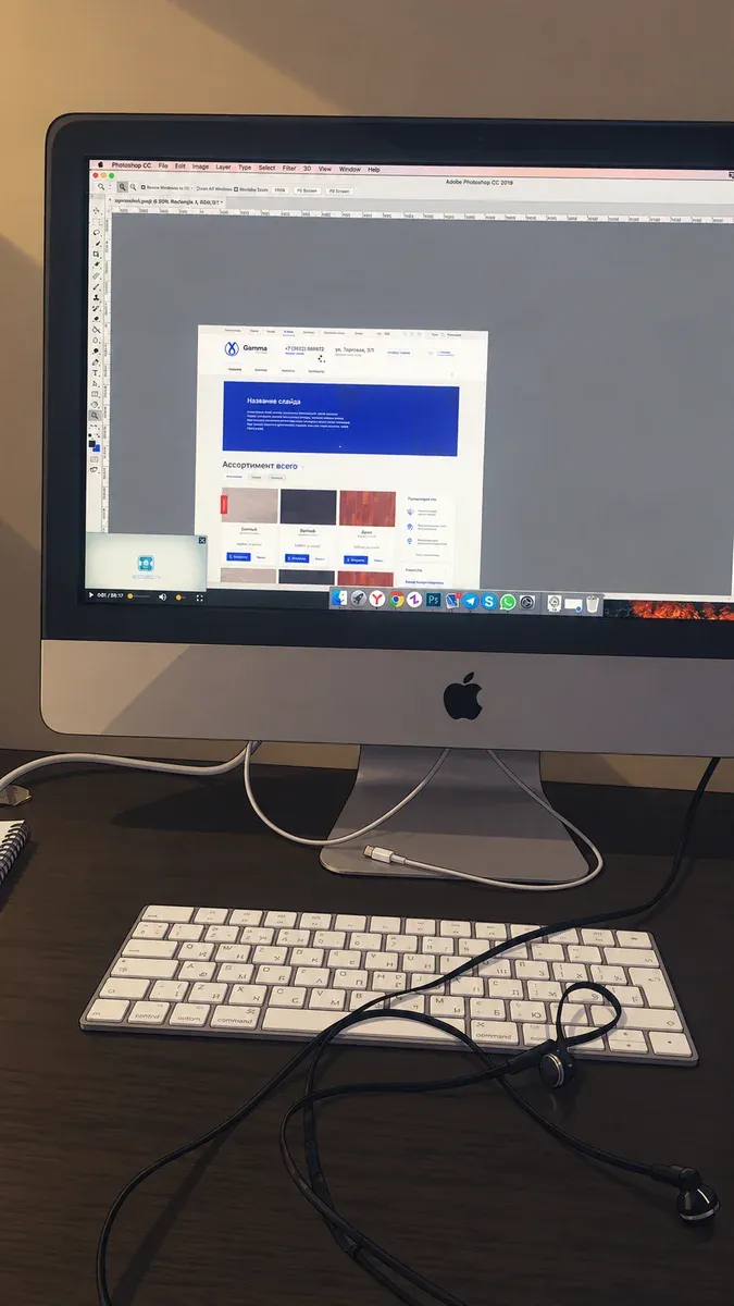 A website layout open in Photoshop on an iMac.