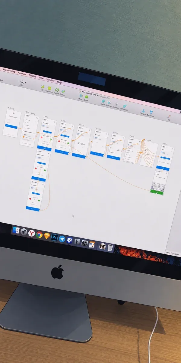 Mobile interface screens connected by prototype links on a computer display.
