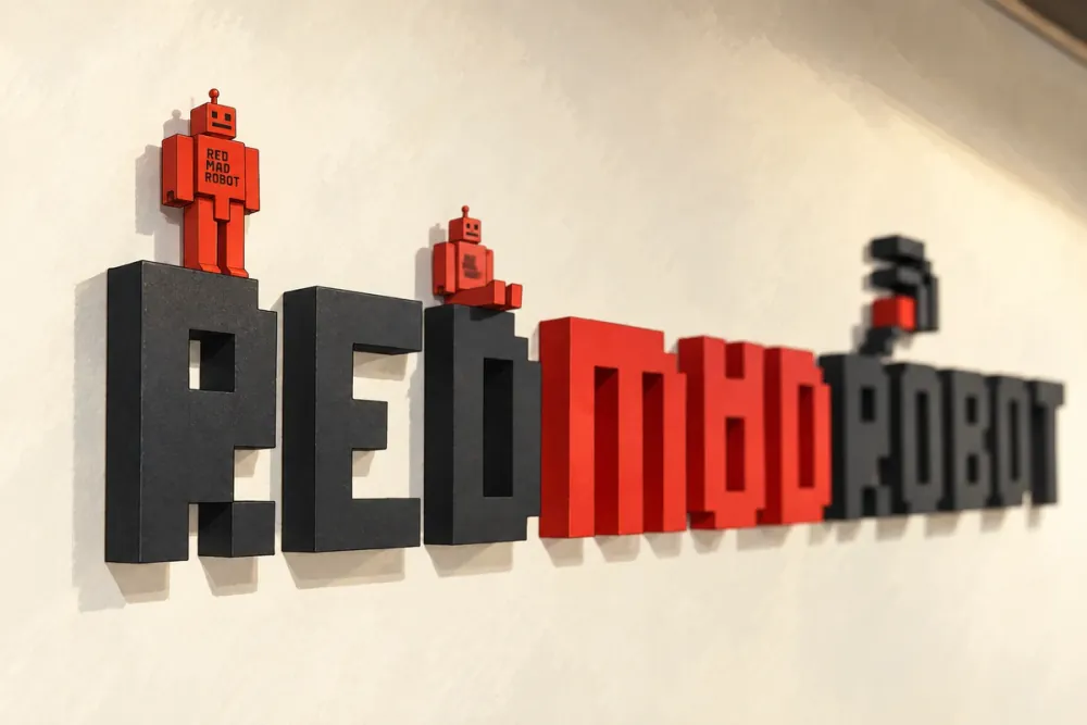 Red robot figurines on the dimensional RED MAD ROBOT sign.
