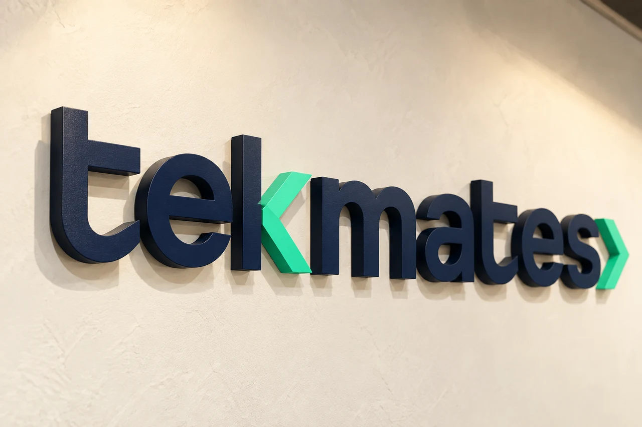 A three-dimensional tekmates sign mounted on a wall.